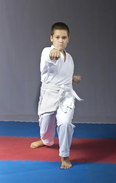 Karate kick in performing the athlete in karategi