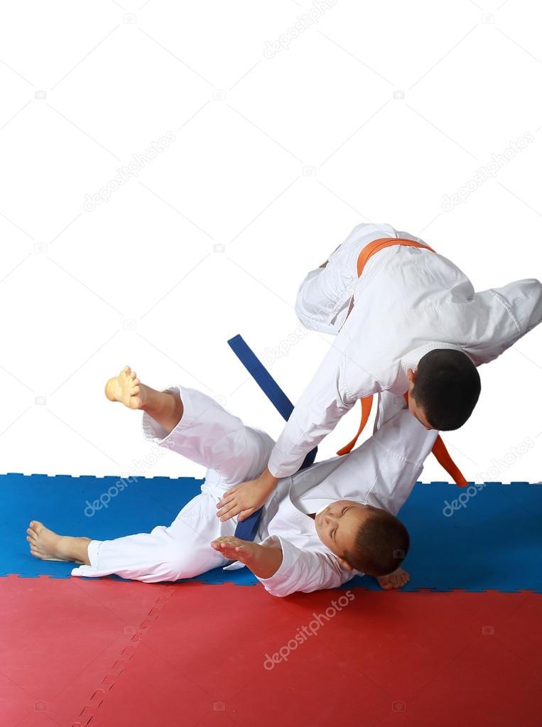 Judo throw in execution athlete with an orange belt