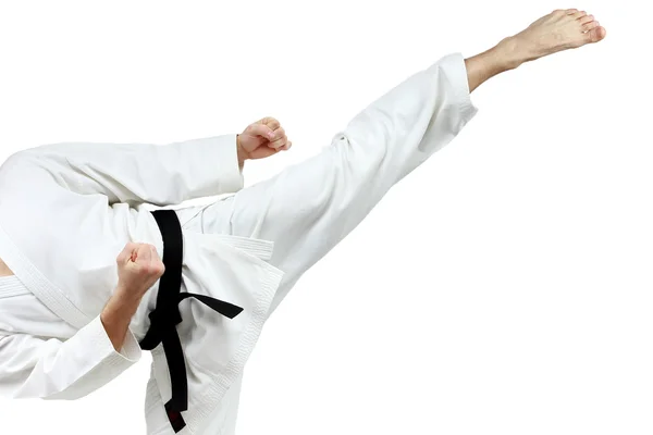 Mawashi geri patada está haciendo deportista en un karategi blanco — Foto de Stock