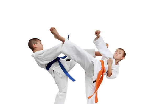 Children sportsmen are beating blows legs — Stock Photo, Image