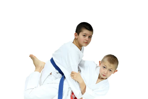 An athlete with a red belt performs grip for throw — Stock Photo, Image