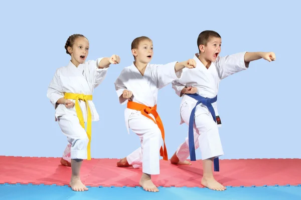 In karategi three athletes are hitting karate kick arm — Stock Photo, Image