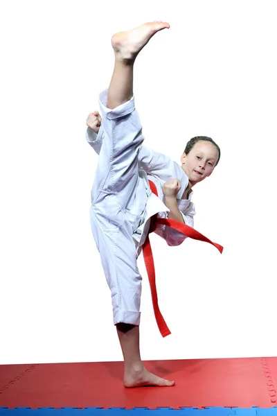 Active sportswoman beats circular a blow mawashi geri — Stock Photo, Image