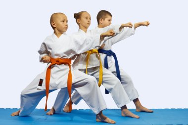 Children in karategi are beating blow gyaku tsuki clipart