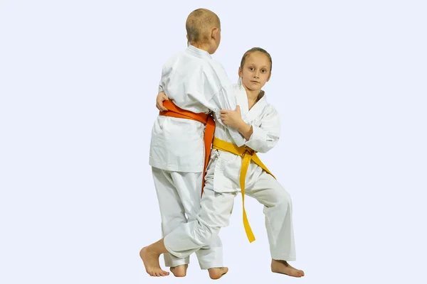 Girl and boy in judogi are training throwing — Stock Photo, Image