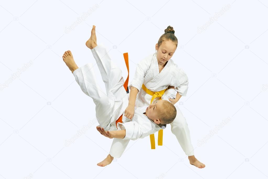 Sportswoman with a yellow belt is makes throw Judo