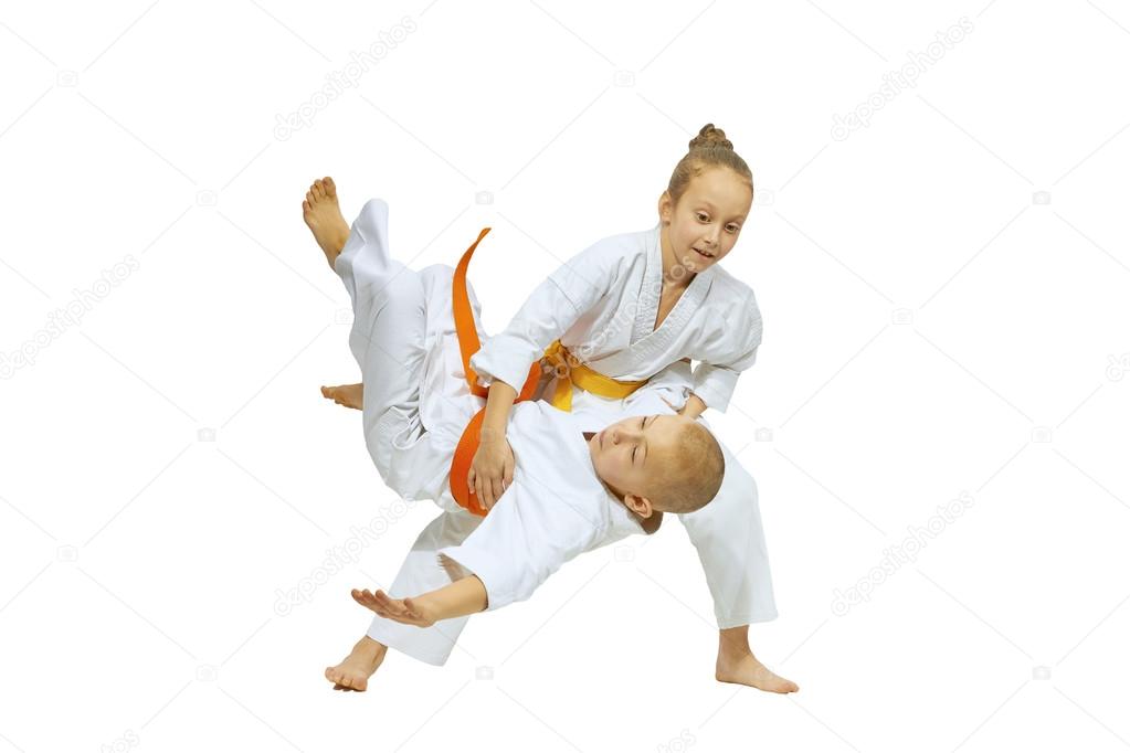 The girl is throwing the boy throw judo