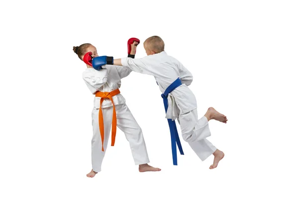 Children with overlays on hands are training punch in jump — Stock Photo, Image