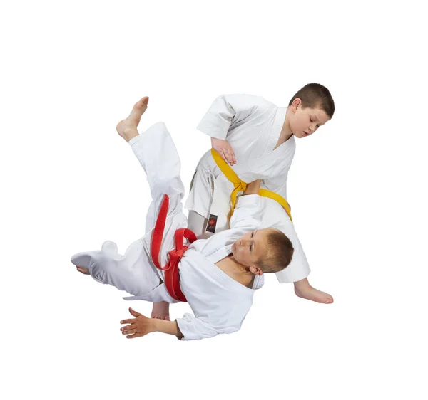 An athlete with a yellow belt throws athlete  with a red belt — Stock Photo, Image