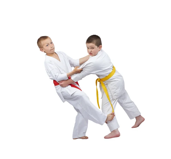 Two boys in judogi are training slicing down under leg — Stock Photo, Image