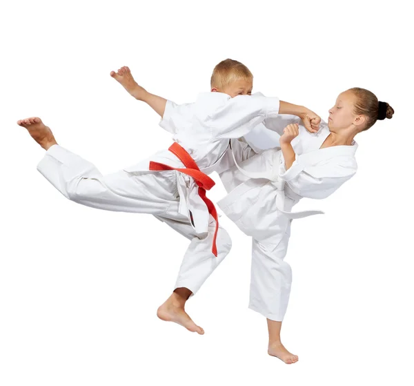 Punch in the jump and kick leg are beating the sportsmens in karategi — Stock Photo, Image