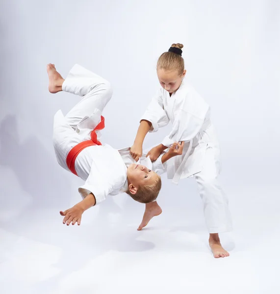 The girl in judogi throws the boy — Stock Photo, Image