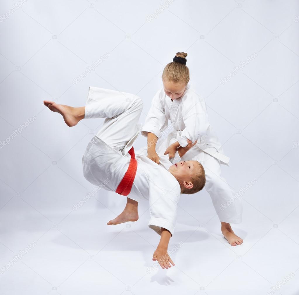Children  in judogi are training throws