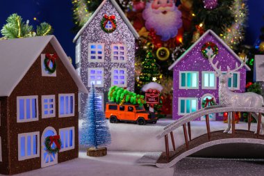 Çok renkli pencereleri olan güzel evleri ve merkezinde geyik olan bir köprüsü olan bir köy.