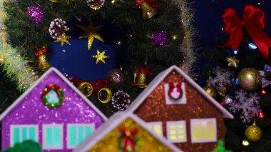 Üç büyük eve yakın çekim, bir kardan adam ve köprüde bir araba.