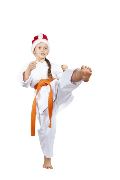 Blow leg sportswoman beats in cap Santa Claus — Stock Photo, Image