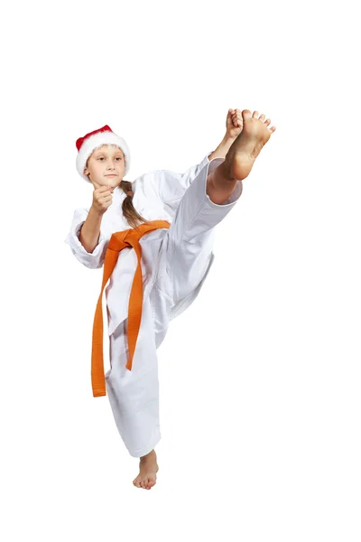 In cap Santa Claus girl beats a kick leg — Stock Photo, Image