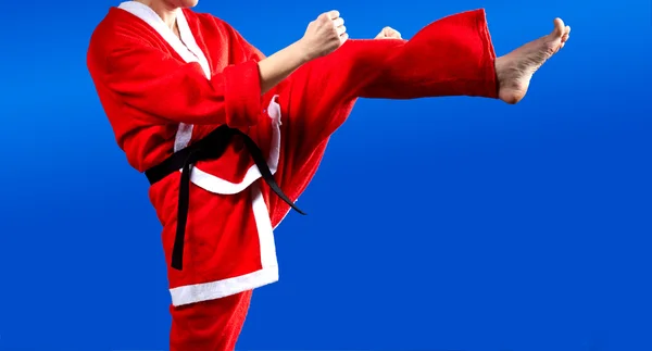 In cloth Santa Claus girl is beating blow leg — Stock Photo, Image