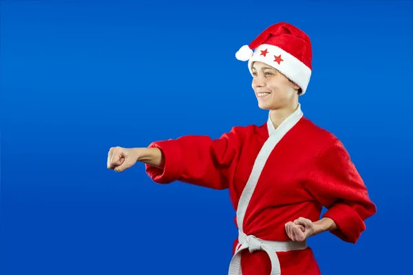 Girl in dressed as Santa Claus beats punch hand — Stock Photo, Image