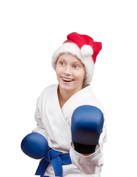 Girl in hat of Santa Claus standing in rack of karate — Stock Photo, Image