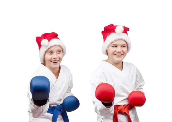 In caps of Santa Claus and with overlays on hands the athletes stand in rack — Stock Photo, Image