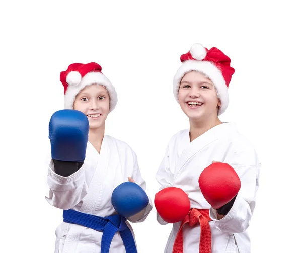 With overlays on hands and in caps of Santa Claus sportsmens are standing in rack — Stock Photo, Image