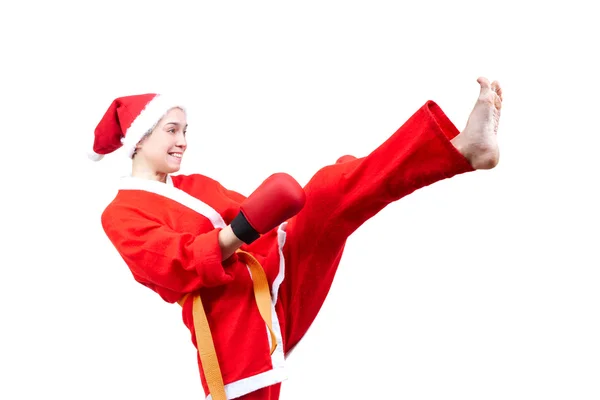 Adult sportswoman in dressed as Santa Claus hits a kick leg — Stock Photo, Image