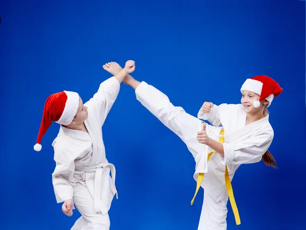 Girl and boy are training paired exercises karate — Stock Photo, Image