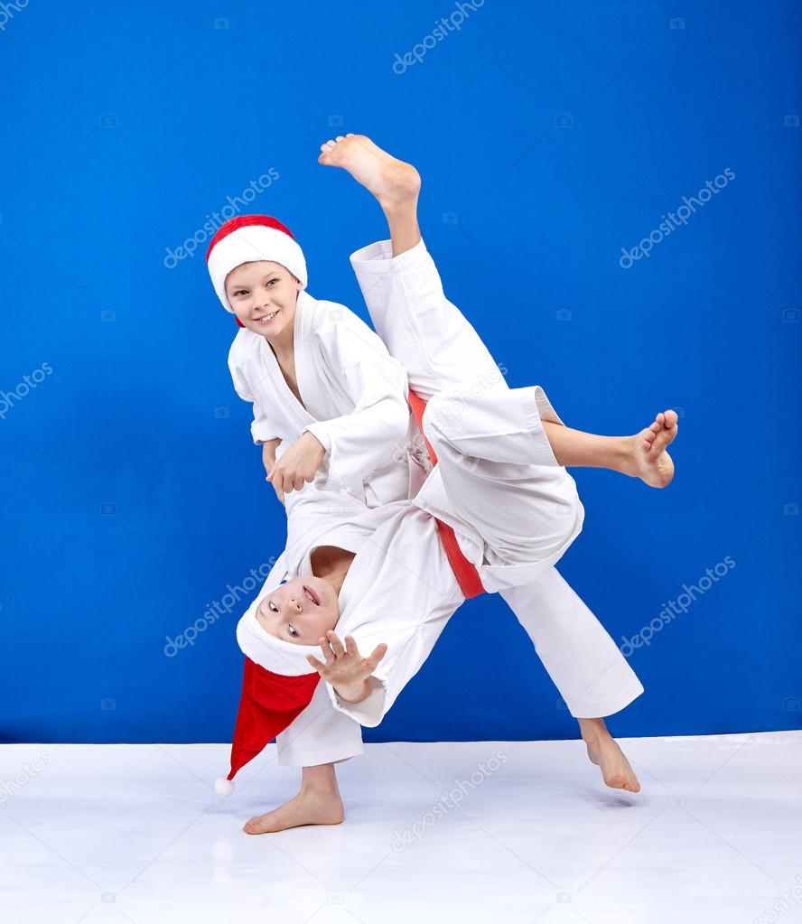 Two athletes in caps of Santa Claus trains throws