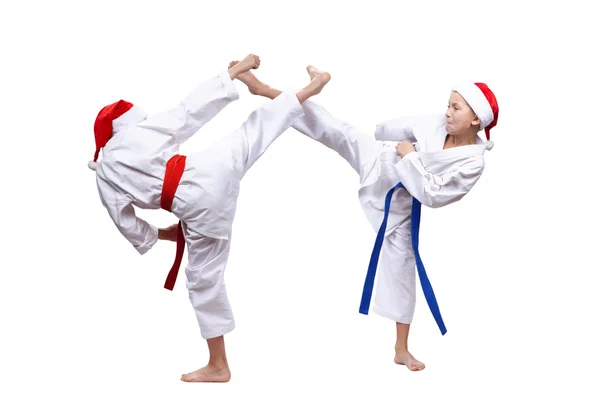 High blows leg children beats in caps of Santa Claus — Stock Photo, Image