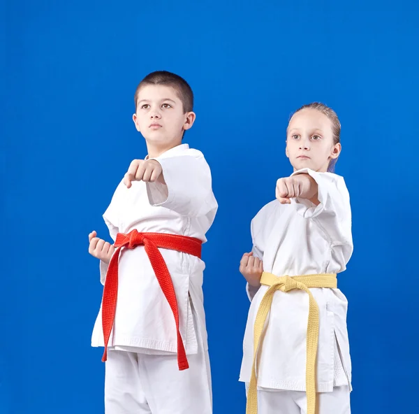 Boy and girl in karategi beats punch hand — Stock Photo, Image