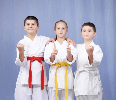 Boy and girl standing in rack of karate and showing the finger super clipart