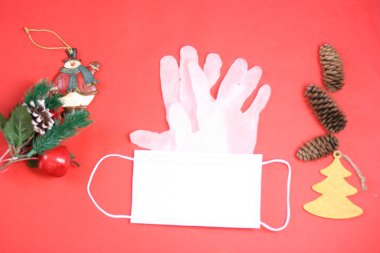 Tıbbi maske, laboratuvar eldivenleri ve kırmızı arka planda yeni yıl süslemeleri. En üst veiw. Tehlikeli bir Ncov Corona virüsü. Coronavirus 2019-ncov konsepti