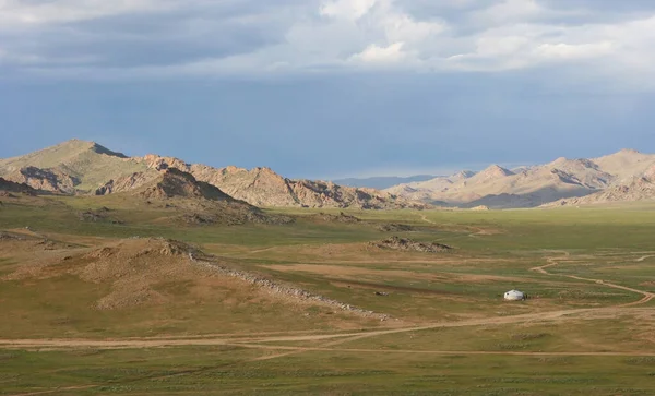Desert mountain slopes and valleys. Mountain mountain range on the background of the steppe. Photo with copy space.