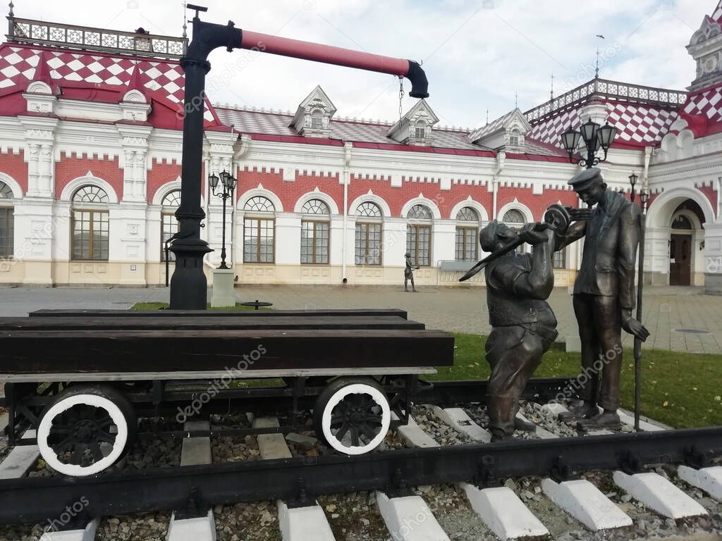 Yekaterinburg, Russia - 20.09.2020: Museum of History, Science and Technology of Sverdlovsk railway, in the past building of the railway station. Sculpture of two railway trackmen near the Old railway
