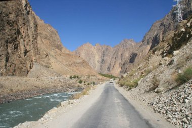 Pamir otoyolu M41 uluslararası karayolu veya Pamirskij trakt. Panj Nehri ve Pamir Dağları. Panj, Amu Darya nehrinin üst kısmıdır. Panoramik manzara. Tacikistan ve Afganistan sınırı, Gorno-badakhshan bölgesi.