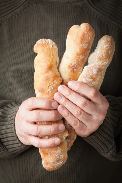 Holding baguettes — Stock Photo, Image