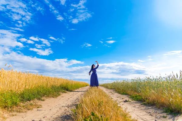 Beautiful brunette woman in wheat field — Stock Photo, Image