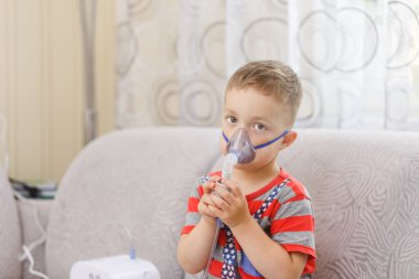 Small boy does therapeutic inhalation clipart