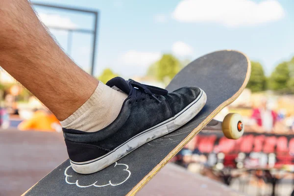 Close-up of skater\'s leg on a skateboard