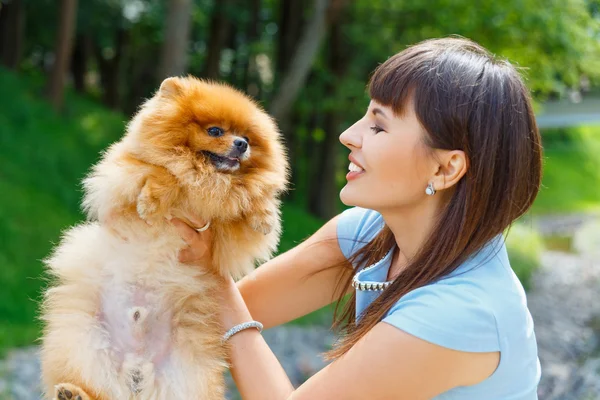 Beautiful young happy girl with Spitz — Stock Photo, Image