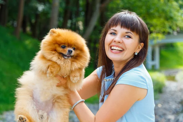 Beautiful young happy girl with Spitz — Stock Photo, Image