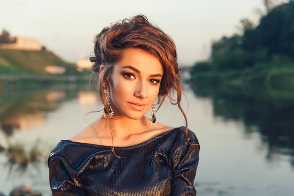 Krásná mladá módní žena pózuje v šatech na pobřeží řeky — Stock fotografie