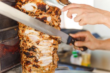 Shawarma meat being cut clipart