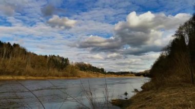 Time lapse - River Neman landscape under blue cloudy sky.