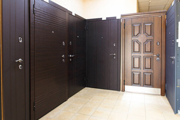 Entrance doors for sale in a specialized store. Buyers prefer metal doors.