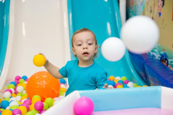 Little boy playing with balls — Stock Photo, Image