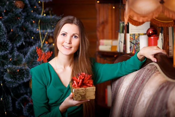 Beautiful woman with Christmas gift — Stock Photo, Image