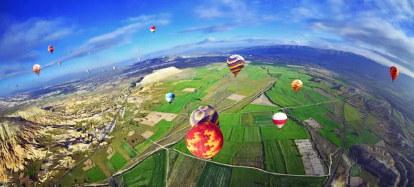 Kolorowy balon latające nad opoka pejzaż w błękitne niebo — Zdjęcie stockowe