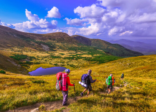 Group of hikers in the mountains, view of Carpathians mountains 